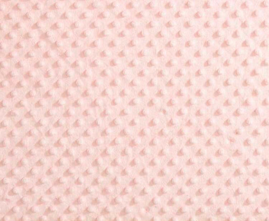 A close-up of a light pink textured fleece fabric with a repeating dotted or dimple pattern.